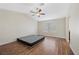Spacious bedroom featuring a ceiling fan, wood-look floors, and window at 8912 Dio Guardi Dr, Las Vegas, NV 89117