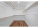 Walk-in closet featuring built-in shelves with wood look flooring at 8912 Dio Guardi Dr, Las Vegas, NV 89117