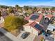 Charming house with a red tile roof and solar panels surrounded by mature landscaping at 8912 Dio Guardi Dr, Las Vegas, NV 89117