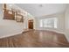 Bright foyer featuring wood floors, a staircase with wood banisters, and a large window at 8912 Dio Guardi Dr, Las Vegas, NV 89117