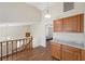 Bright hallway with wood floors, cabinet, and staircase with natural lighting at 8912 Dio Guardi Dr, Las Vegas, NV 89117