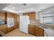 Well-lit kitchen showcasing wooden cabinetry, modern white appliances, and tile backsplash for style and functionality at 8912 Dio Guardi Dr, Las Vegas, NV 89117