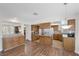 Open concept kitchen with tile floors, wood cabinets and modern appliances, seamlessly connected to the dining area at 8912 Dio Guardi Dr, Las Vegas, NV 89117