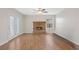 Inviting living room with a brick fireplace, french doors, wood-look floors and natural light at 8912 Dio Guardi Dr, Las Vegas, NV 89117