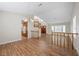 Open-concept living room features wood floors, staircase and bright natural light at 8912 Dio Guardi Dr, Las Vegas, NV 89117