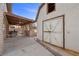 Outdoor kitchen with covered patio, BBQ, a weathered white barn-style storage building at 8912 Dio Guardi Dr, Las Vegas, NV 89117