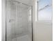 Bathroom showcasing a modern glass shower with marble tiles at 8912 Dio Guardi Dr, Las Vegas, NV 89117