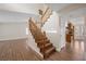 Elegant wood staircase connecting levels, enhancing the home's appeal with its rich wood tones and design at 8912 Dio Guardi Dr, Las Vegas, NV 89117