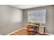 Bedroom featuring a window with blinds, a work desk, and wood-style flooring at 976 El Camino Way, Boulder City, NV 89005