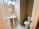 Cozy powder room featuring a pedestal sink, toilet, and neutral-colored walls at 8149 Sandy Slope Ct, Las Vegas, NV 89113