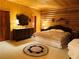 Spacious bedroom offers wood paneled walls, carpeted floor, and a comfortable-looking bed with matching furniture at , Mount Charleston, NV 89124