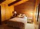 Charming bedroom with light colored walls, decorative accents, and log-style wood paneling at , Mount Charleston, NV 89124