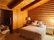 Charming bedroom with log-style wood paneling, a teddy bear, and a cozy chair at , Mount Charleston, NV 89124