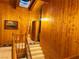 Bright hallway with wood paneling, skylight, and carpeted stairs leading to an upper level at , Mount Charleston, NV 89124