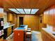 A cozy kitchen with custom cabinets, a skylight, and an island with seating at , Mount Charleston, NV 89124