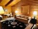 Comfortable living room featuring wood paneled walls, a decorative rug, and a cozy seating arrangement at , Mount Charleston, NV 89124