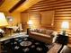 Comfortable living room featuring wood paneled walls, a decorative rug, and a cozy seating arrangement at , Mount Charleston, NV 89124