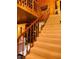 Carpeted staircase with wood banister showcasing the home's open design and wood finishes at , Mount Charleston, NV 89124