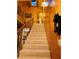Carpeted staircase with wood banister showcasing the home's open design and wood finishes at , Mount Charleston, NV 89124