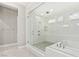 Modern bathroom showcasing a glass-enclosed shower, luxurious tub, and bright lighting at 10016 Copper Edge Rd, Las Vegas, NV 89148