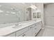 Modern bathroom featuring double sinks, white cabinetry, quartz countertops, and a large mirror at 10016 Copper Edge Rd, Las Vegas, NV 89148