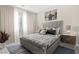 Staged bedroom with neutral walls, carpet flooring, and grey accents at 10016 Copper Edge Rd, Las Vegas, NV 89148