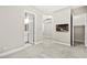 Bedroom featuring neutral carpet, access to bathroom and closet, and a tv at 10016 Copper Edge Rd, Las Vegas, NV 89148