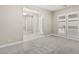 Bedroom with neutral walls and plush carpet opens to doorways and windows fitted with plantation shutters at 10016 Copper Edge Rd, Las Vegas, NV 89148