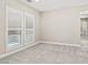 Light-filled, carpeted room with shuttered windows and neutral color palette at 10016 Copper Edge Rd, Las Vegas, NV 89148