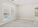 Neutral bedroom featuring plush carpet, shuttered windows, and modern baseboards for a clean aesthetic at 10016 Copper Edge Rd, Las Vegas, NV 89148