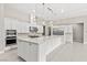 Bright kitchen featuring a large island with white countertops, stainless steel appliances, and modern pendant lighting at 10016 Copper Edge Rd, Las Vegas, NV 89148