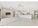 Spacious kitchen and living area with white cabinetry, pendant lights, and stainless steel appliances at 10016 Copper Edge Rd, Las Vegas, NV 89148