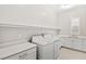 Functional laundry room featuring a washer, dryer, sink, countertop, storage, and overhead shelving at 10016 Copper Edge Rd, Las Vegas, NV 89148