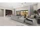 Bright living room featuring modern furnishings, a cozy sectional sofa, and a stylish wine storage unit at 10016 Copper Edge Rd, Las Vegas, NV 89148