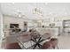 Open-concept living space with dining area, sofa, and a modern kitchen with a large island and white cabinets at 10016 Copper Edge Rd, Las Vegas, NV 89148