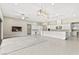 Open-concept living space with tile flooring, modern lighting, and white cabinets at 10016 Copper Edge Rd, Las Vegas, NV 89148