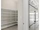 Walk-in pantry with ample shelving space, conveniently located next to the stainless steel refrigerator at 10016 Copper Edge Rd, Las Vegas, NV 89148