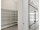 Walk-in pantry with white shelving and tile flooring located off of the kitchen at 10016 Copper Edge Rd, Las Vegas, NV 89148