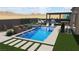 Stunning backyard oasis features a luxurious pool, spa, pergola, and lush landscaping at 10016 Copper Edge Rd, Las Vegas, NV 89148