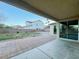 Covered back patio overlooks lawn area, desert landscaping, and adjacent houses at 10105 Prattville Ave, Las Vegas, NV 89148