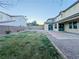 Lush backyard with healthy lawn area, a patio, and desert landscaping behind the home at 10105 Prattville Ave, Las Vegas, NV 89148