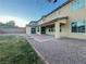 Expansive backyard featuring a covered patio, a lush lawn, and a low-maintenance gravel area at 10105 Prattville Ave, Las Vegas, NV 89148