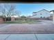 Covered back patio view of brick patio, lawn area and backyard landscaping at 10105 Prattville Ave, Las Vegas, NV 89148