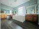 Bright bathroom features a soaking tub, double vanity, and wood-look floors at 10105 Prattville Ave, Las Vegas, NV 89148