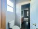 Bathroom featuring oak vanity, toilet, modern vinyl floor, and access to bedroom at 10105 Prattville Ave, Las Vegas, NV 89148