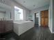 Bright bathroom features a soaking tub, double vanity, and wood-look floors at 10105 Prattville Ave, Las Vegas, NV 89148