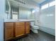 Bathroom features oak vanity, toilet, tub, shower with white tile surround at 10105 Prattville Ave, Las Vegas, NV 89148