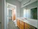 Hall bathroom features oak vanity, large mirror, toilet, and towel rack at 10105 Prattville Ave, Las Vegas, NV 89148