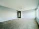 Spacious carpeted room with ceiling fan and an entry door at 10105 Prattville Ave, Las Vegas, NV 89148