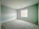 Neutrally painted room featuring a large window with blinds and carpet floors at 10105 Prattville Ave, Las Vegas, NV 89148